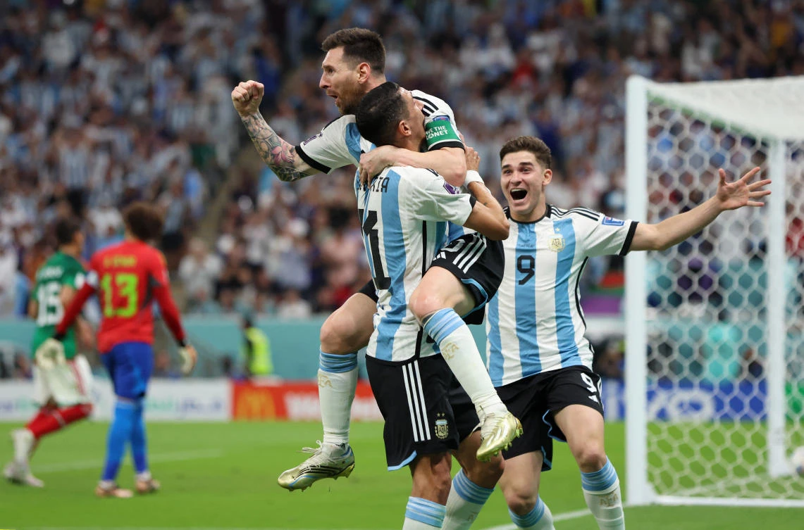 Argentina’s Lionel Messi celebrates scoring their first goal with Angel Di Maria and Julian Alvarez during their FIFA World Cup Qatar 2022 match against Mexico at the Lusail Stadium on Saturday. (Reuters)