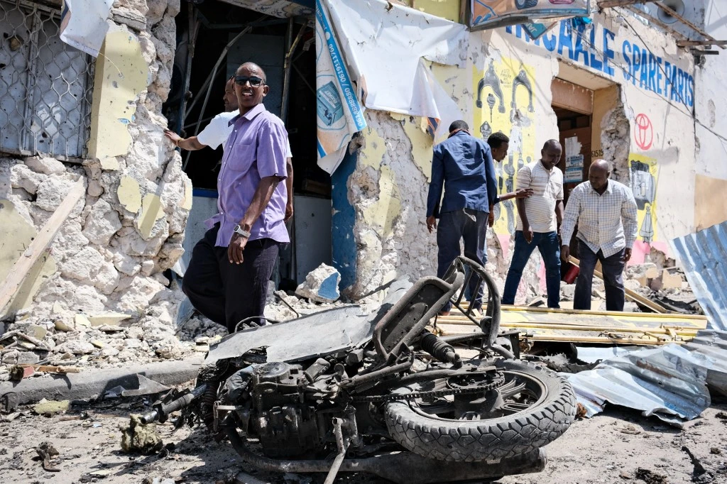People clear debris in front of the destroyed Hayat Hotel after a deadly 30-hour siege by Al-Shabaab militants in Mogadishu on August 21, 2022. (File/AFP)