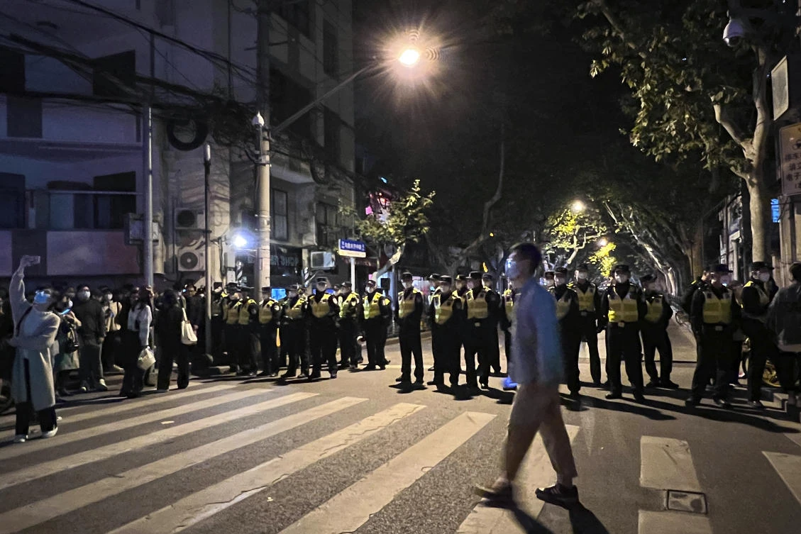 Chinese police officers block off access to a site where protesters had gathered in Shanghai on Nov. 27, 2022. (AP)
