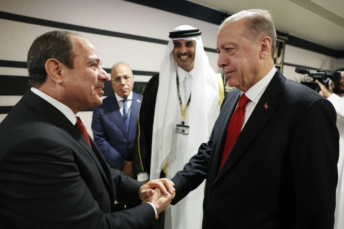 Turkish President Recep Tayyip Erdogan shakes hands with Egyptian President Abdel Fattah el-Sisi during the opening ceremony of the 2022 FIFA World Cup in Qatar. (File/AFP)