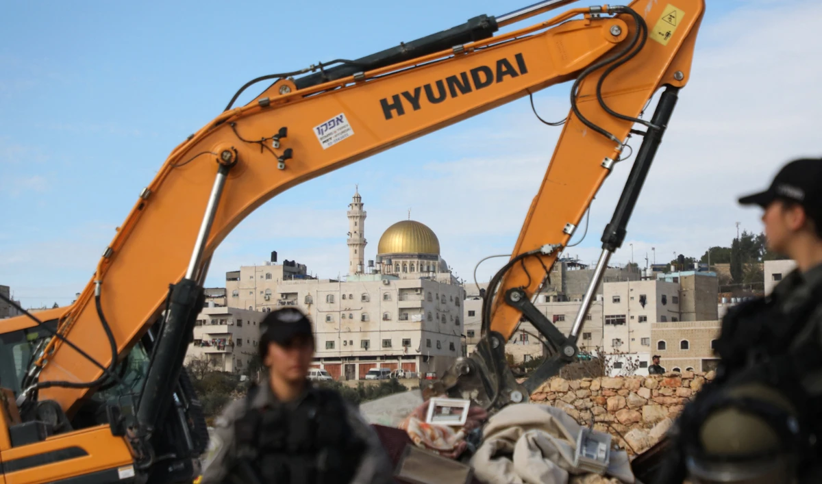 Excavators of the Israeli army demolish two Palestinian houses in the Jabal Johar area of Hebron city, near the Kiryat Arba Israeli settlement, in the occupied West Bank, on November 28, 2022. (AFP/File)