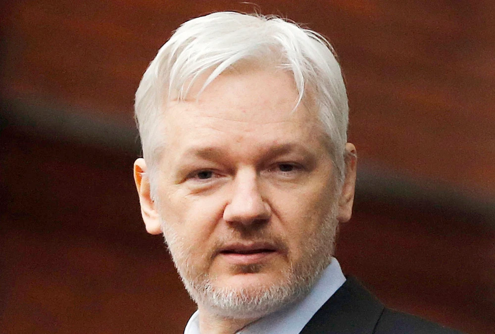 WikiLeaks founder Julian Assange stands on the balcony of the Ecuadorean Embassy to addresses waiting supporters and media in London, Friday, Feb. 5, 2016. (AP)