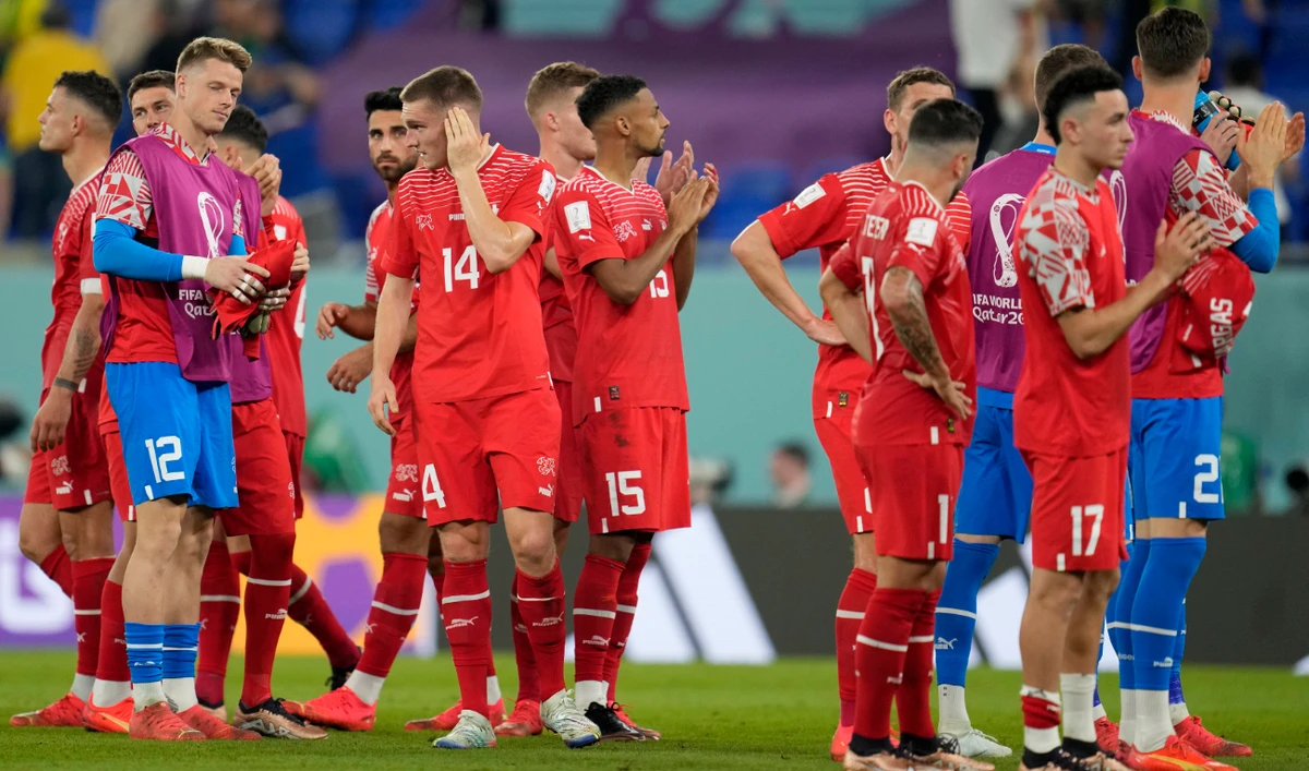 Swiss players react after losing the World Cup Group G soccer match against Brazil at the Stadium 974 in Doha Monday. (AP)