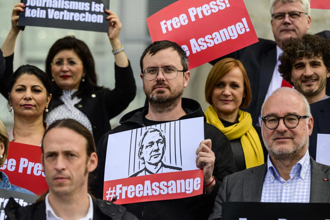 Gabriel Shipton (C), brother of Wikileaks founder Julian Assange, demonstrates at the Reichstag building in Berlin, on October 19, 2022. (AFP/File)