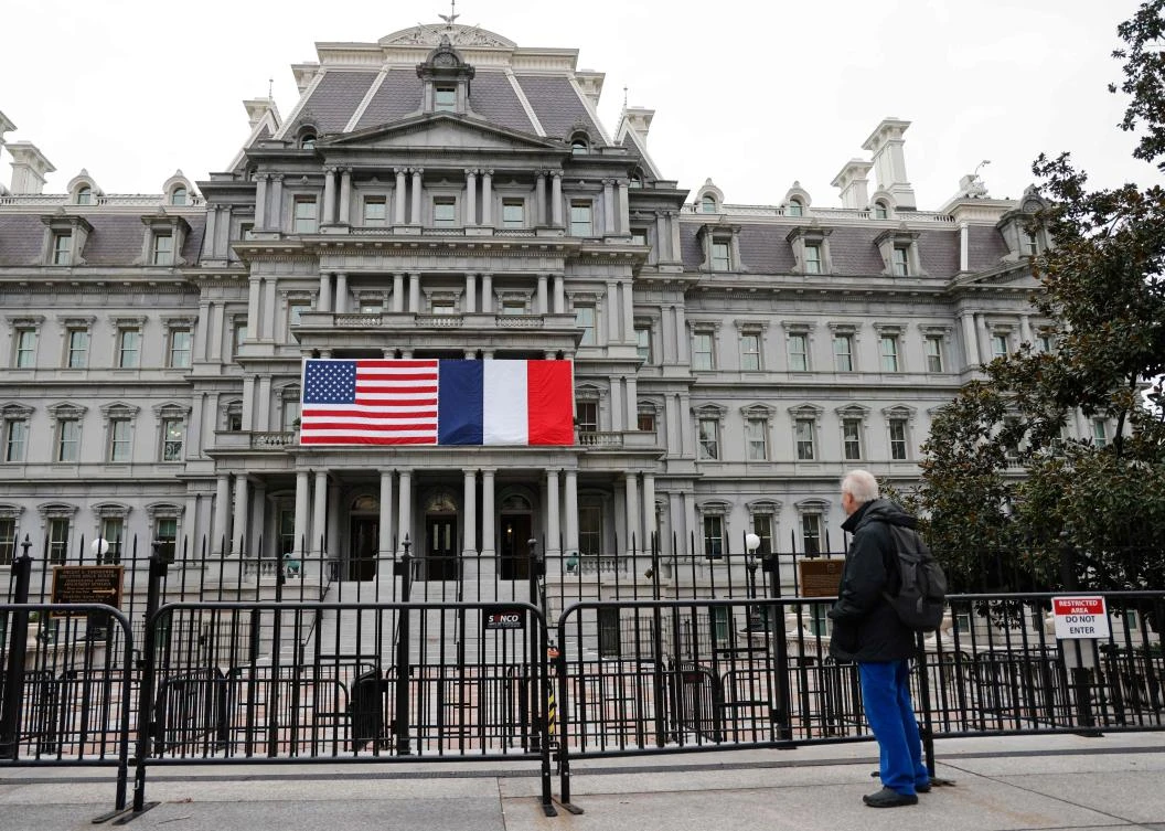 The French and US flags adorn the Eisenhower Executive Office Building next to the White House for the state visit of French President Emmanuel Macron, Washington, D.C., Nov. 29, 2022. (AFP)