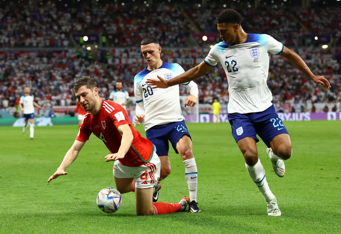 Wales’ Ben Davies in action with England’s Jude Bellingham and Phil Foden during their FIFA World Cup Qatar 2022 — Group B match at Ahmad Bin Ali Stadium, Al Rayyan on Tuesday. (Reuters)