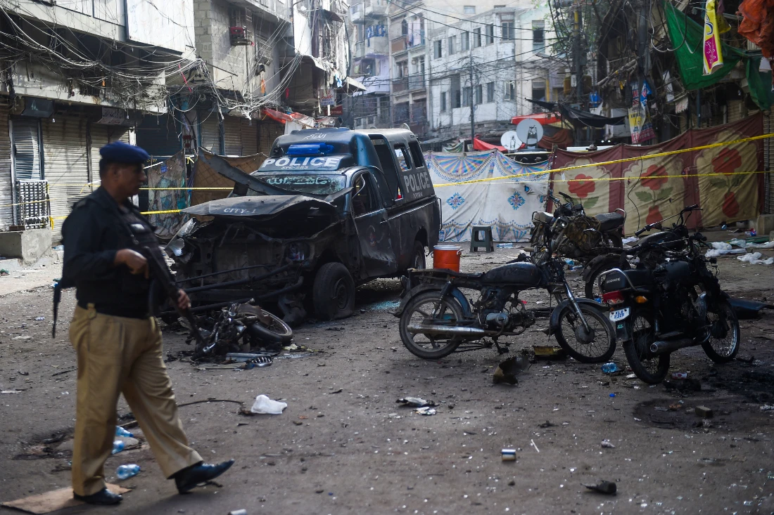 Policeman stands guard at the site of a bomb blast, that killed one and injured nine people in May. (File/AFP)
