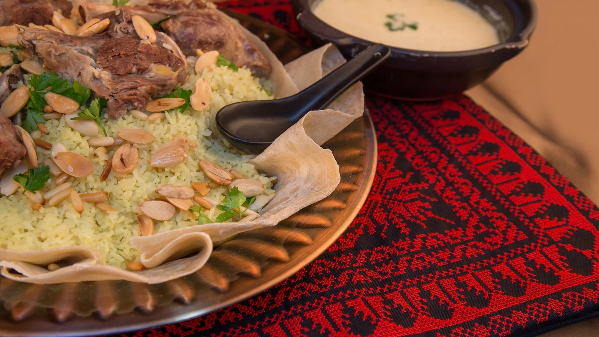 Mansaf consists of large chunks of meat, a yogurt sauce and rice over a layer of thin bread. (Twitter/@HalalTravelscom)