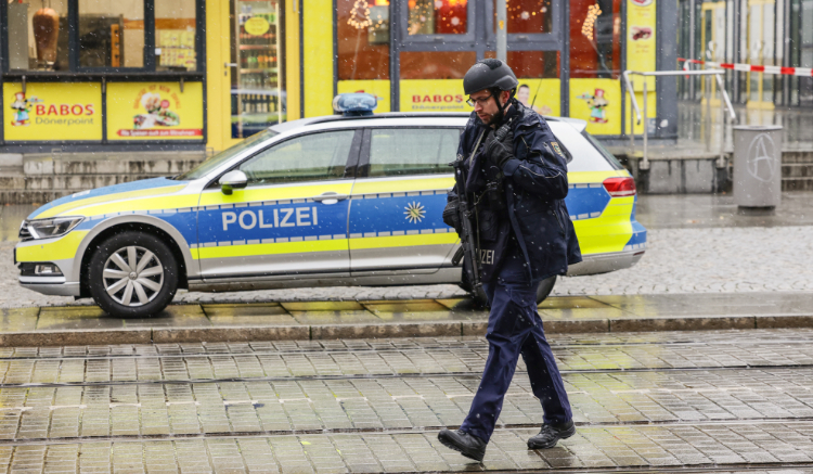 A German police officer walks in the center of the city of Dresden, eastern Germany, on December 10, 2022. (AFP)