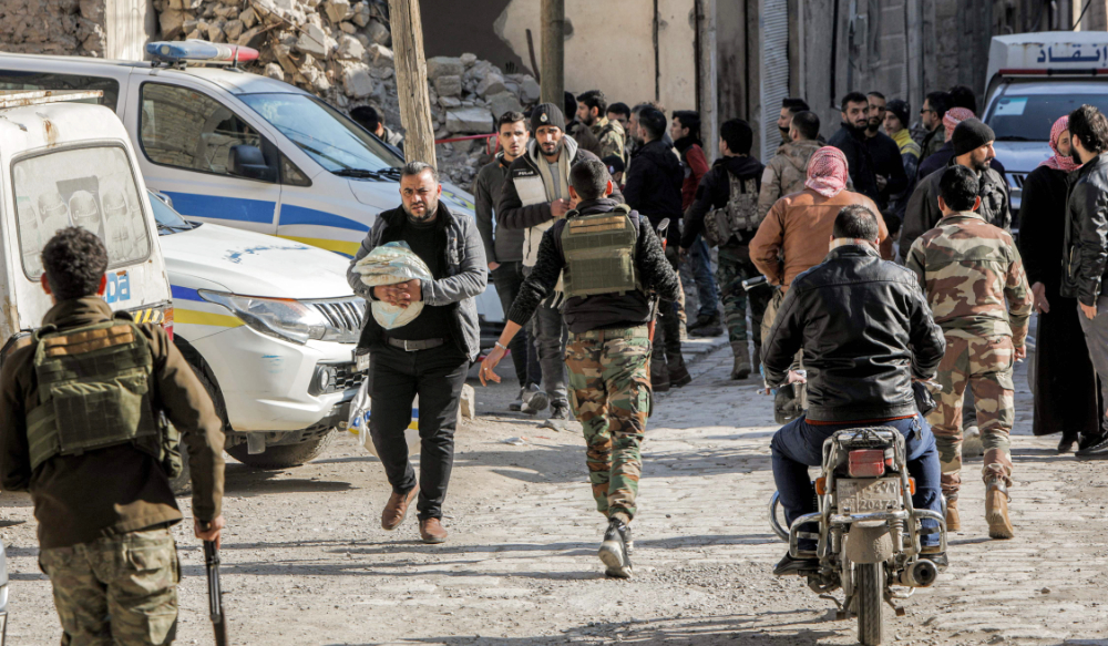 Syrian rebel fighters and rescue teams are pictured at the site of an alleged US-led coalition drone strike al-Bab, Syria. (AFP)