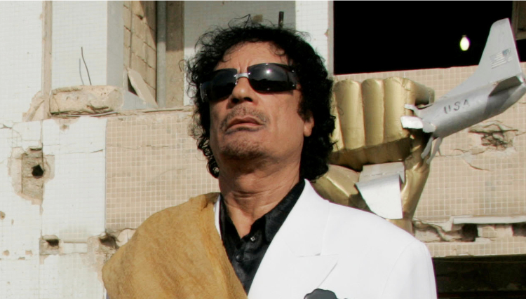 Libya's former President Gaddafi listens to national anthems at Bab Azizia Palace in Tripoli. (REUTERS)