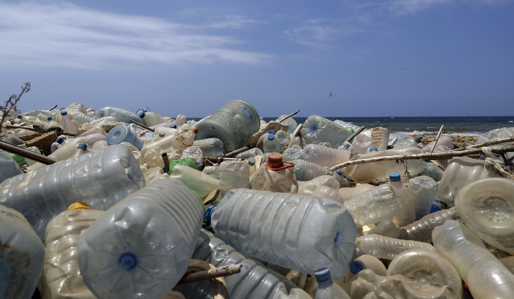 A sewage discharge area next to piles of plastic bottles and gallons washed away by the water on the seaside of Beirut. (AFP)