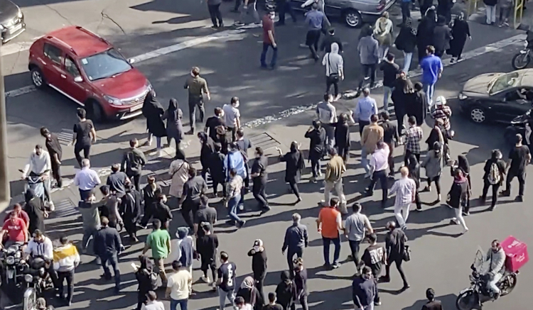 People blocking an intersection during a protest to mark 40 days since the death in custody of Mahsa Amini, in Tehran. (AP)
