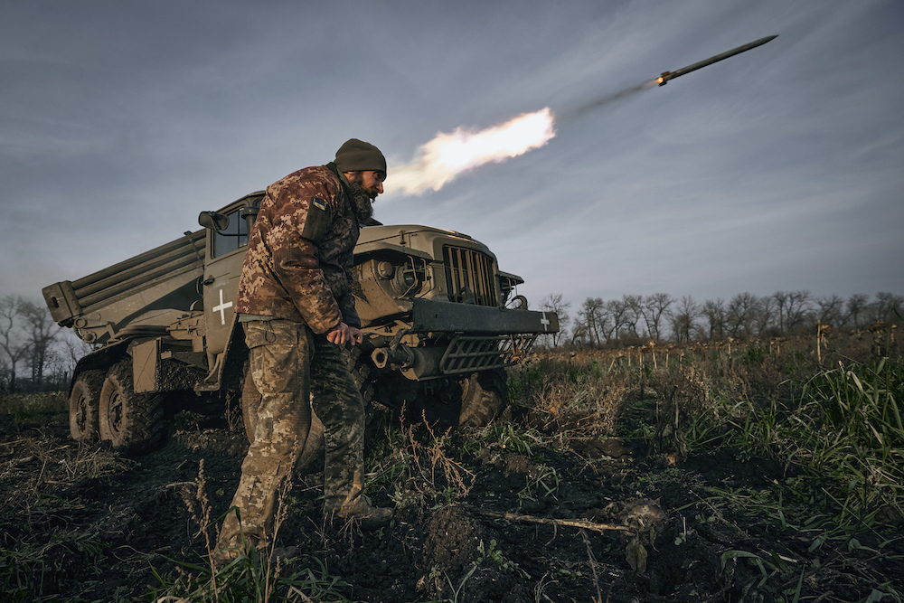 Above, Ukrainian military personnel fire rockets at Russian positions near Bakhmut of the Donetsk. (AP)
