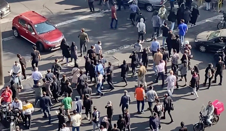 People blocking an intersection during a protest to mark 40 days since the death in custody of Mahsa Amini, in Tehran. (AP)
