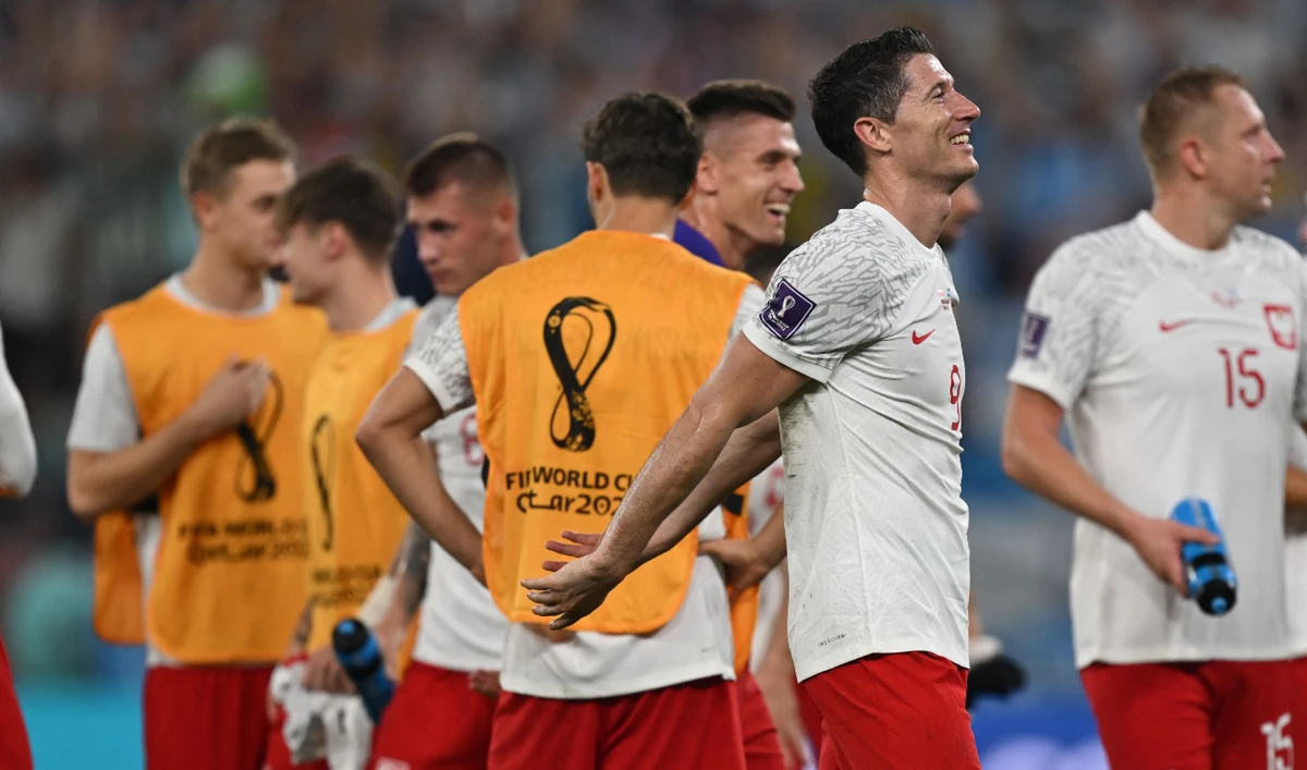 Poland's forward Robert Lewandowski celebrates with teammates as they advance to the round of 16 following the World Cup Group C match between against Argentina at Stadium 974 in Doha on Wednesday. (AFP)