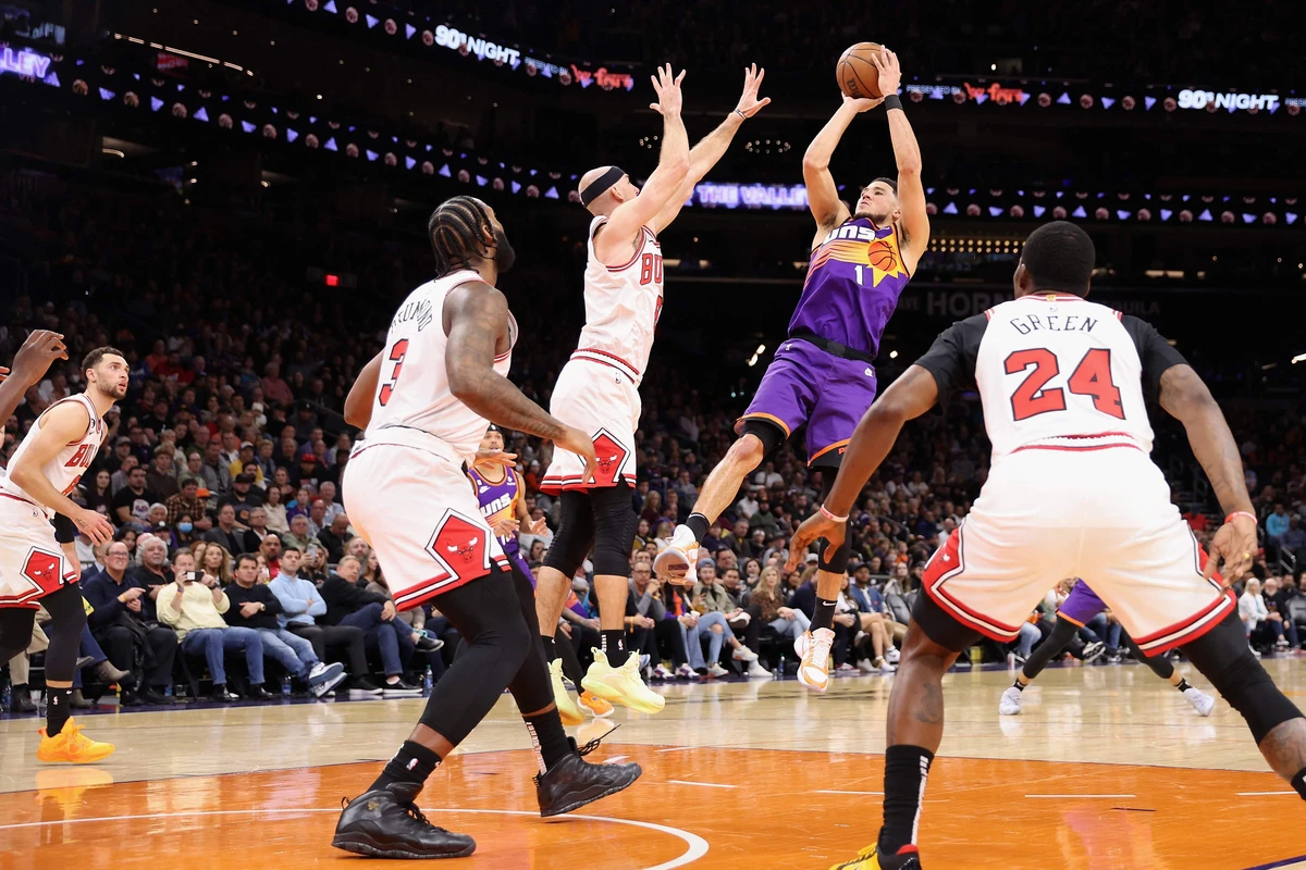 Devin Booker of the Phoenix Suns puts up a shot over Alex Caruso of the Chicago Bulls during the first half of their NBA game at Footprint Center on Wednesday in Phoenix, Arizona. (AFP)