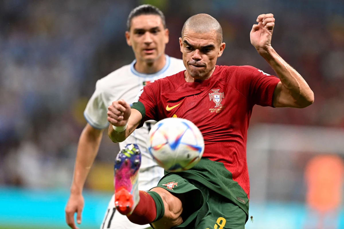 Portugal's defender Pepe (front) kicks the ball in front of Uruguay's forward Darwin Nunez during the Qatar World Cup. AFP