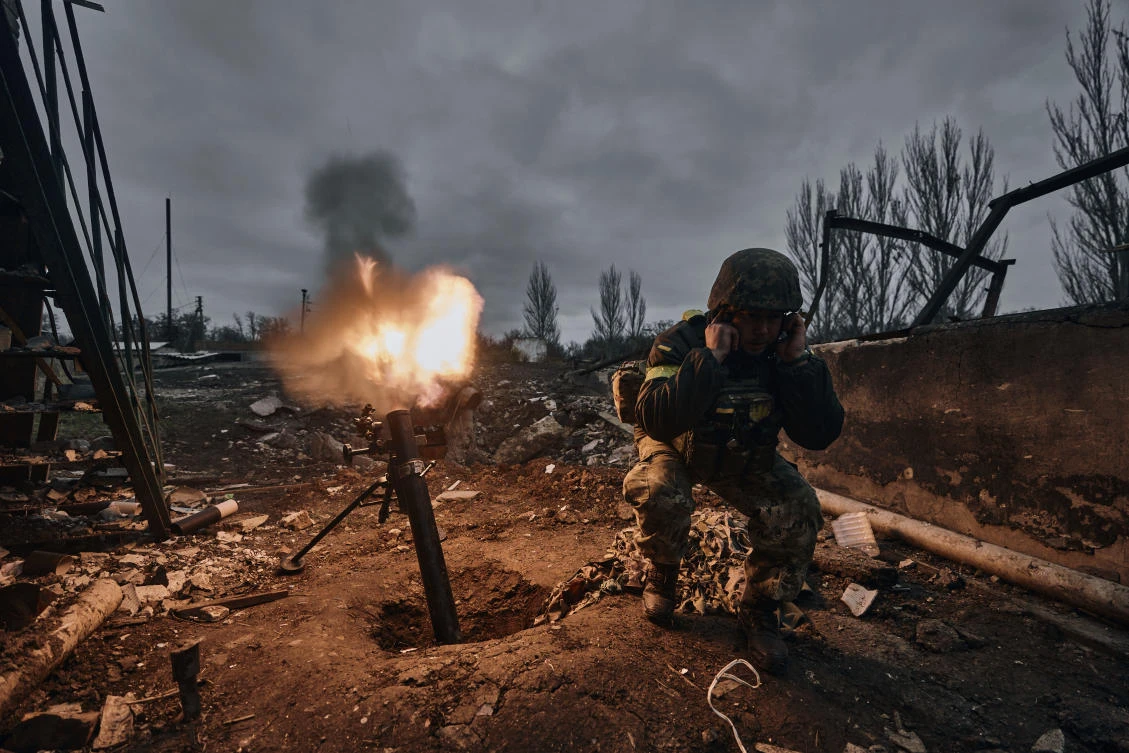 Above, a Ukrainian soldier fires a mortar at Russian positions in Bakhmut of the Donetsk region. (AP)