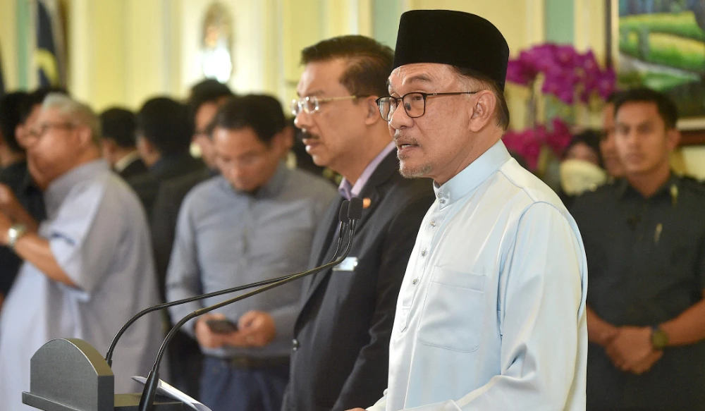 Malaysia’s Prime Minister Anwar Ibrahim speaks during a press conference to announce new cabinet members at the Prime Minister’s office in Putrajaya on December 2, 2022. (AFP)