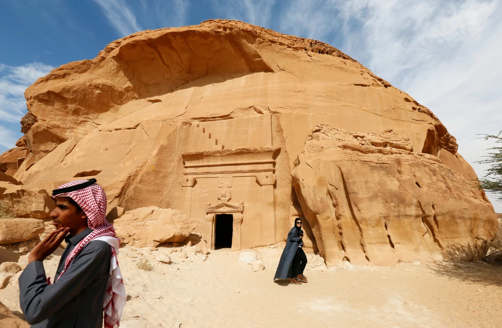 Visitors tour at majestic rock-hewn tombs of Madain Saleh near the city al-Ula, Saudi Arabia. (REUTERS)