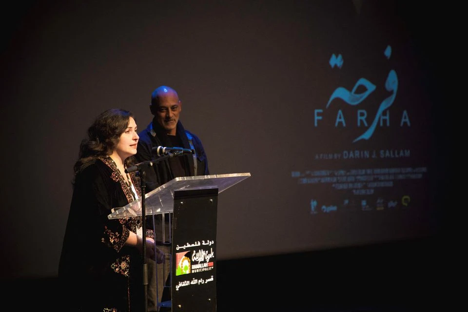 Producer Deema Azar and actor Ashraf Barhom introduce ‘Farha,’ the closing film of the Palestine Cinema Days festival, Ramallah, Israeli-occupied West Bank, Nov. 7, 2022. (Reuters)