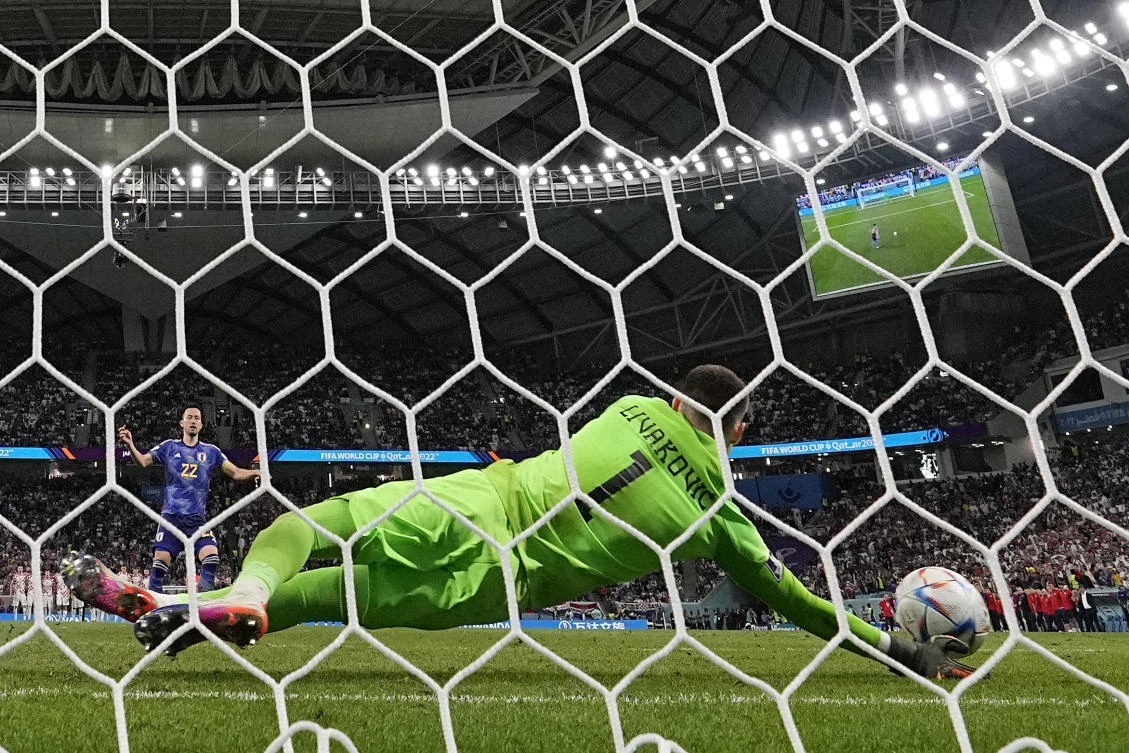 Dominik Livakovic saves Maya Yoshida’s penalty, Al Janoub Stadium, Al Wakrah, Qatar, Monday, Dec. 5, 2022. (AP Photo)