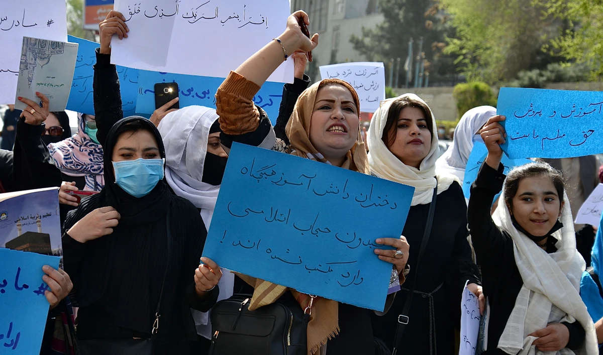 Afghan women and girls take part in a protest in front of the Ministry of Education in Kabul on March 26, 2022, demanding that high schools be reopened for girls. (AFP/File)