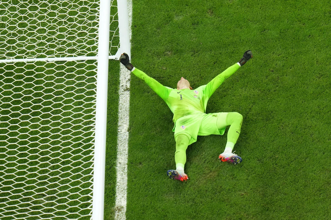 Croatia’s goalkeeper Dominik Livakovic celebrates after Brazil’s Marquinhos missed a penalty shot during their World Cup quarterfinal match, at the Education City Stadium in Al Rayyan on Friday. (AP)