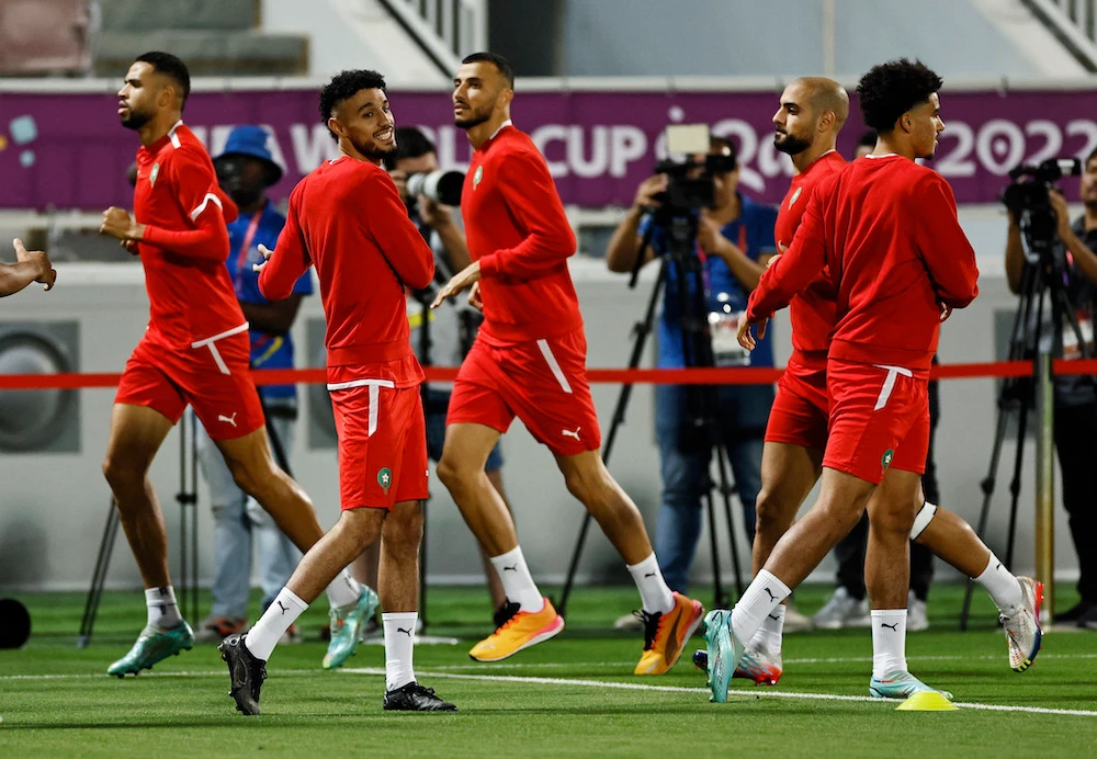 Morocco’s Noussair Mazraoui, Sofyan Amrabat and teammates during training at Al-Duhail Stadium in Doha on Dec. 9. 2022. (Reuters)