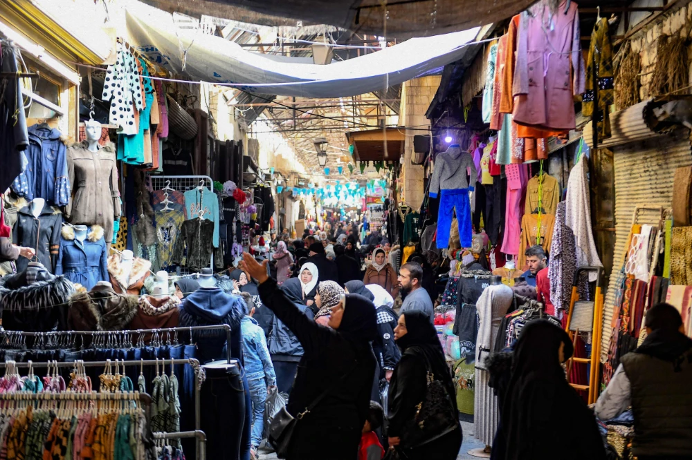The exchange rate reached more than 6,000 Syrian pounds to the US dollar for the first time. (AFP)