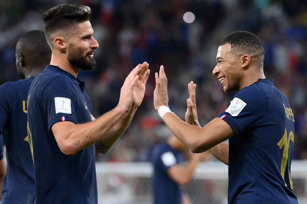 France's forward Kylian Mbappe (R) celebrates scoring his team's second goal with forward Olivier Giroud against Poland. AFP