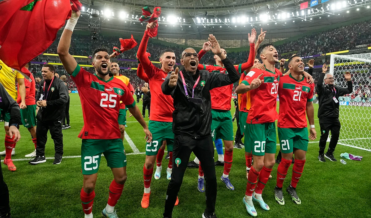 Morocco's players celebrate after the World Cup quarterfinal soccer match between Morocco and Portugal, at Al Thumama Stadium in Doha, Qatar, on December 10, 2022. (AP)