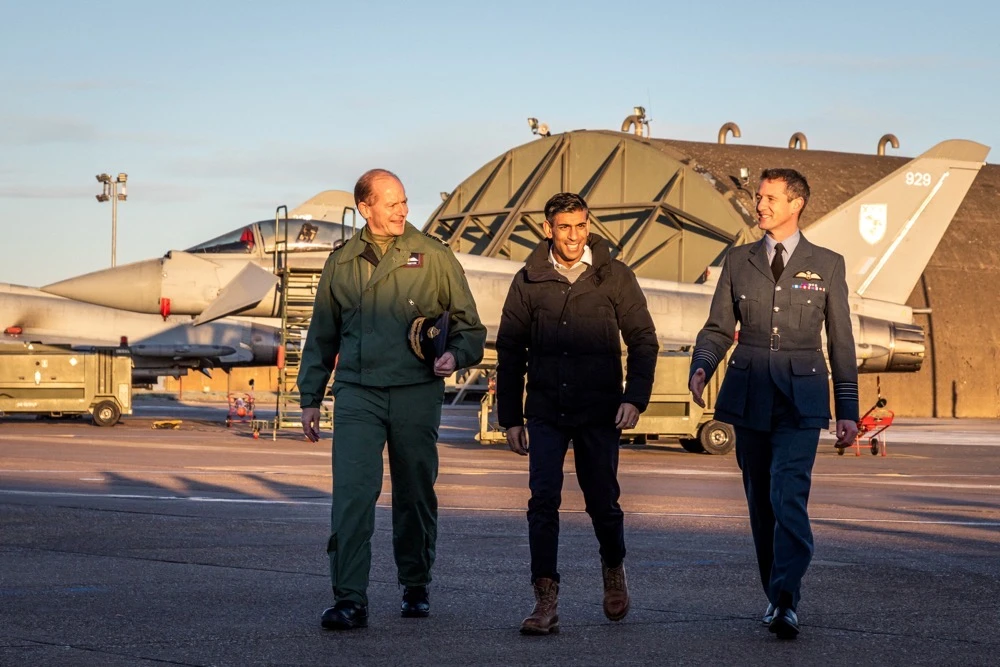 British PM Rishi Sunak walks with Chief of the Air Staff Sir Mike Wigston and Station Commander of RAF Coningsby, Group Captain Billy Cooper at during a visit to RAF Coningsby, Lincolnshire, on Friday. (Reuters)