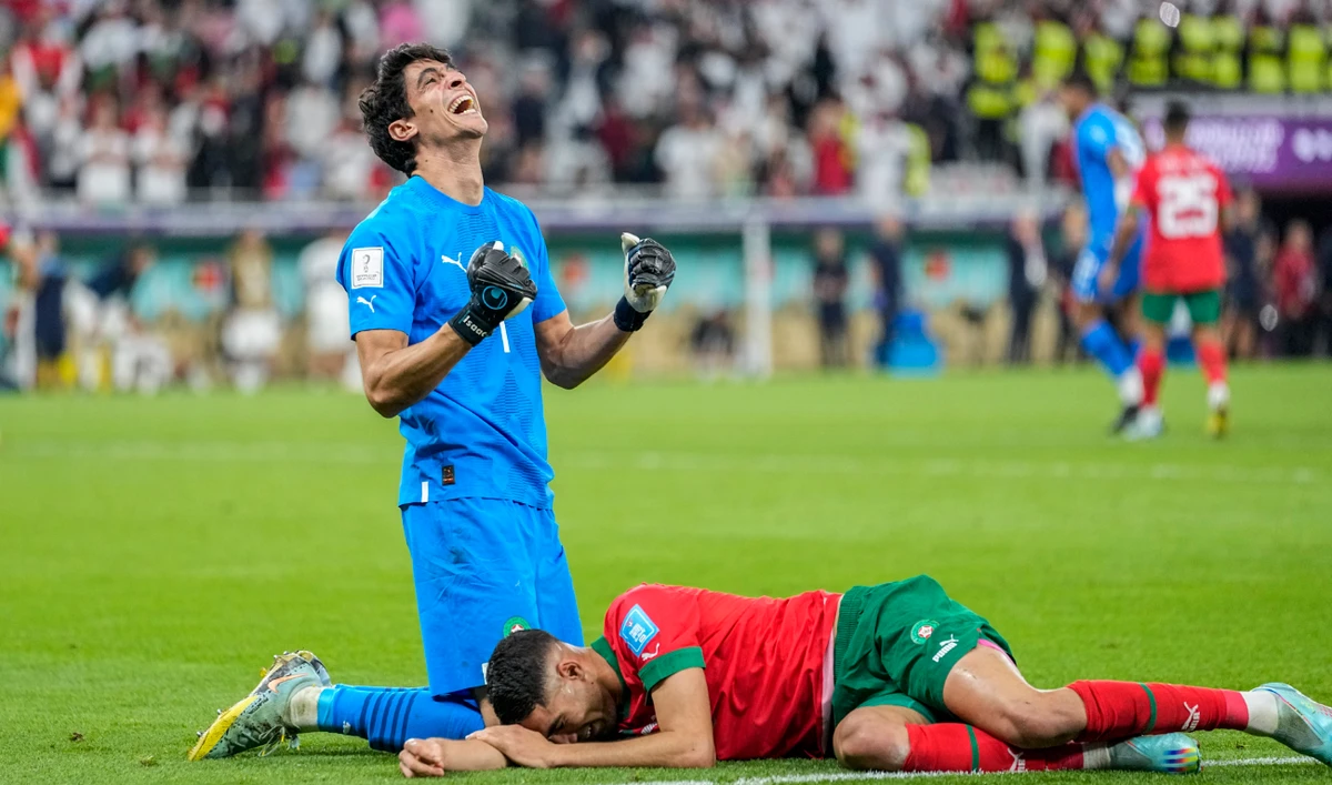 Morocco's goalkeeper Yassine Bounou, left, celebrates with his teammate Achraf Hakimi their team victory over Portugal during their World Cup quarterfinal at Al Thumama Stadium in Doha Saturday. (AP)