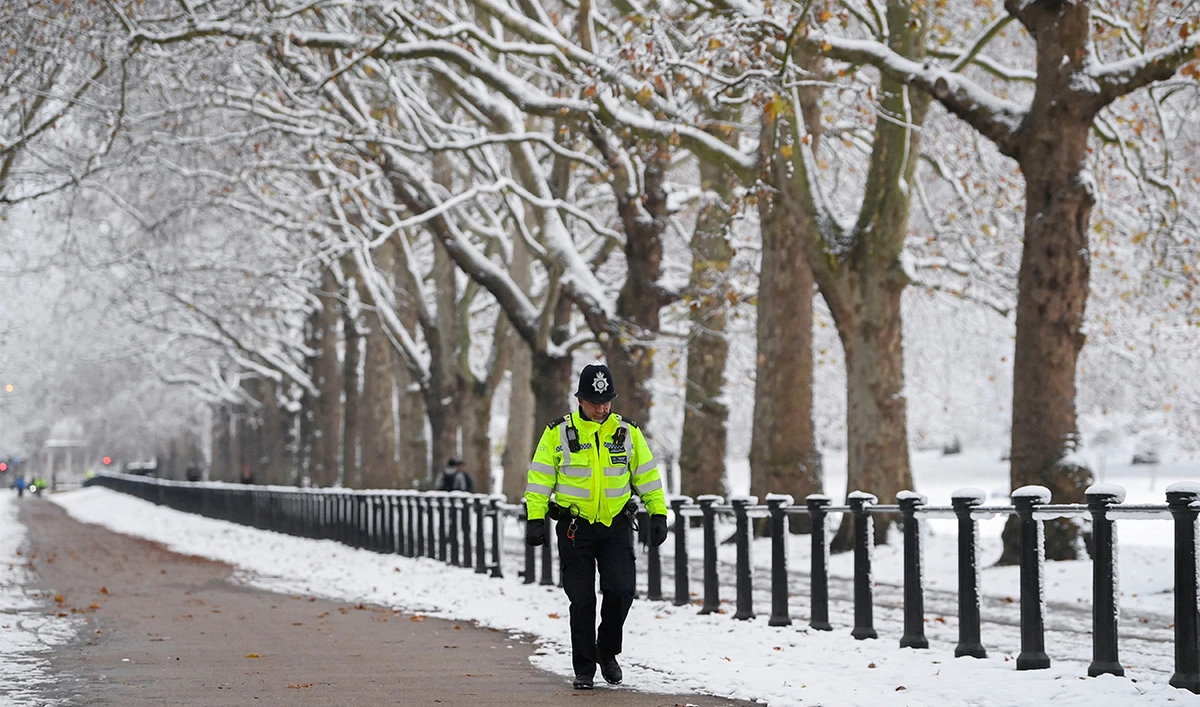 A police officer walks on the street as cold weather continues, in London, Britain, on December 12, 2022. (REUTERS)