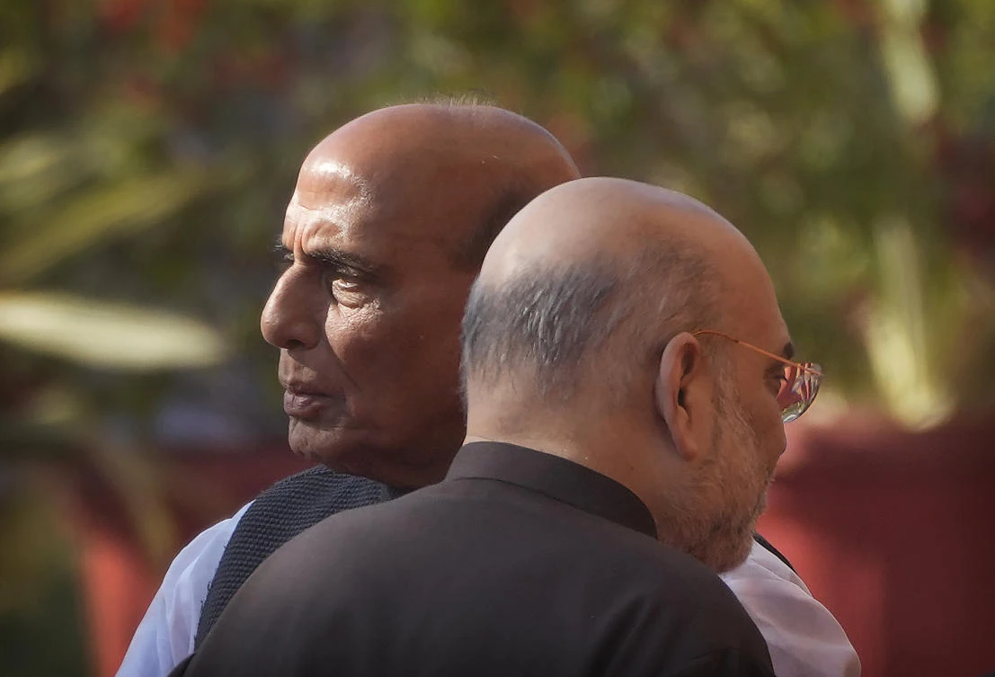 Indian Defence Minister Rajnath Singh, left, and Home Minister Amit Shah talk to their cabinet colleagues as they wait to pay respect to the martyrs of 2001 terror attack on Parliament House, in New Delhi, Tuesday, Dec. 13, 2022. (AP)