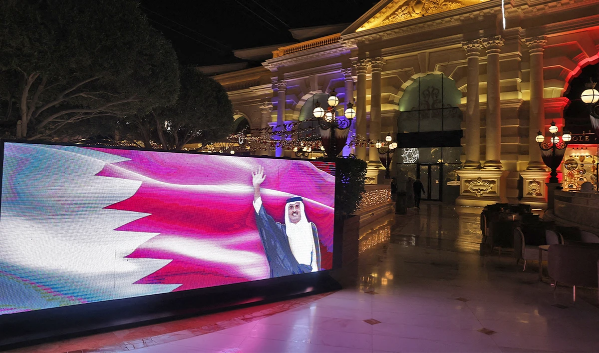 An image of Qatar's Emir Sheikh Tamim bin Hamad al-Thani is seen on a video wall in Doha on December 12, 2022, during the Qatar 2022 World Cup football tournament. (AFP)