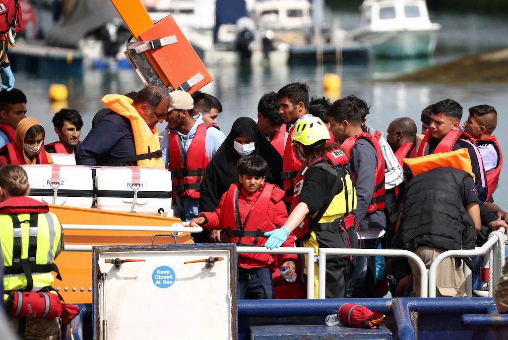 Migrants arrive at Dover harbour on board a Border Force vessel, after being rescued while attempting to cross the English Channel, in Dover, Britain, August 24, 2022. (Reuters)