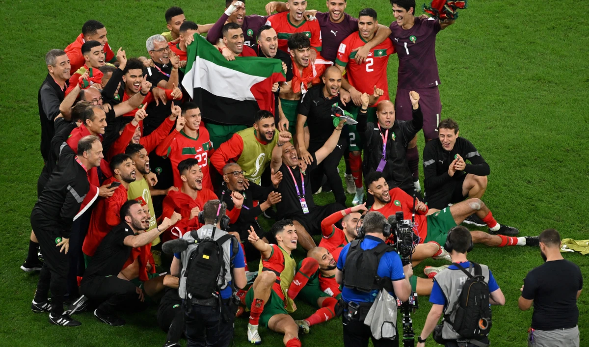 Morocco's players celebrate at the end of the Qatar 2022 World Cup round of 16 football match against Spain at the Education City Stadium on December 6, 2022. (AFP)