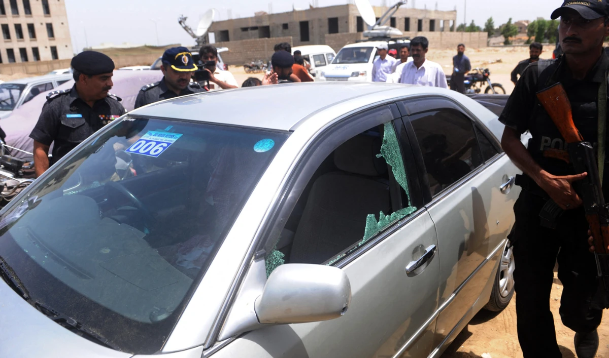 Pakistani police officials inspect the bullet-riddled vehicle of a Saudi diplomat after a deadly attack in Karachi on May 16, 2011. (AFP)