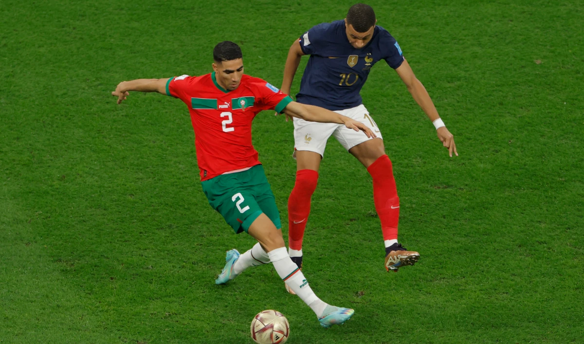 Morocco's defender #02 Achraf Hakimi (L) fights for the ball with France's forward #10 Kylian Mbappe during the Qatar 2022 World Cup semi-final football match against France Al-Bayt Stadium on December 14, 2022. (AFP)