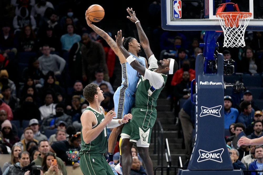 Memphis Grizzlies guard Ja Morant goes up for a dunk against Milwaukee Bucks forward Bobby Portis in the first half of an NBA basketball game Thursday in Memphis, Tenn.