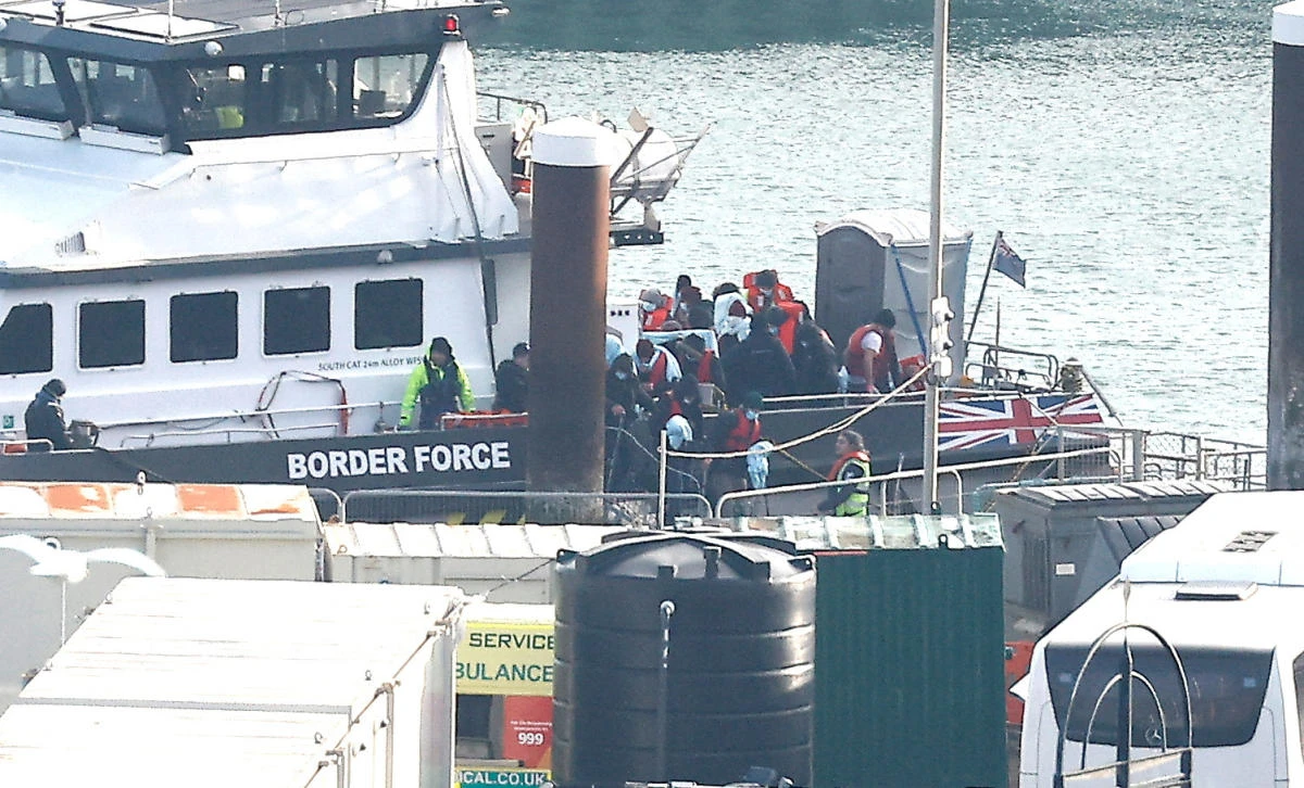 People believed to be migrants disembark a Border Force vessel after being rescued from the English Channel while crossing from France, in Dover, Britain on December 17, 2022. (Reuters)