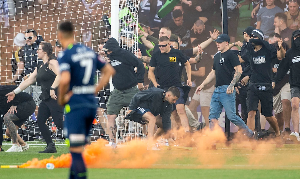 Fans invade the pitch during the A-League match between Melbourne City and Melbourne Victory at AAMI Park in Melbourne on Saturday. (AP)