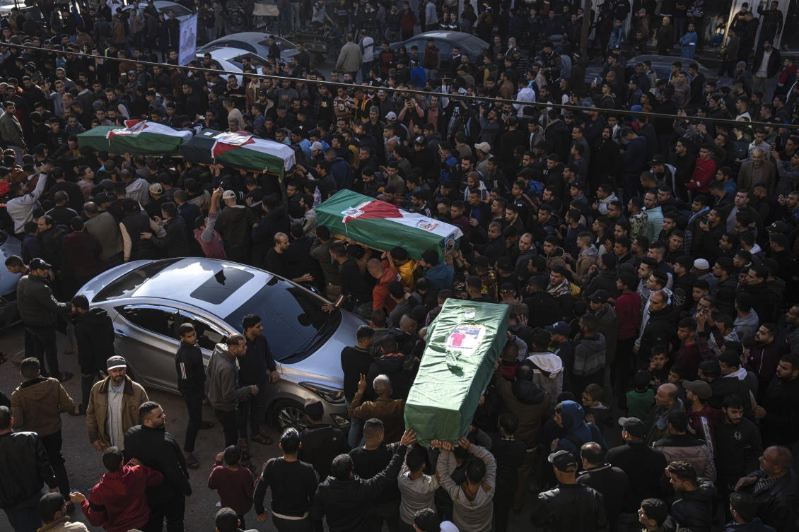 Palestinians carry the bodies of four Palestinian migrants who died off the Tunisian coast. Eight young Palestinian men drowned off the coast of Tunisia nearly two months ago triyingto sail to new lives in Europe. (AP Photo/Fatima Shbair)