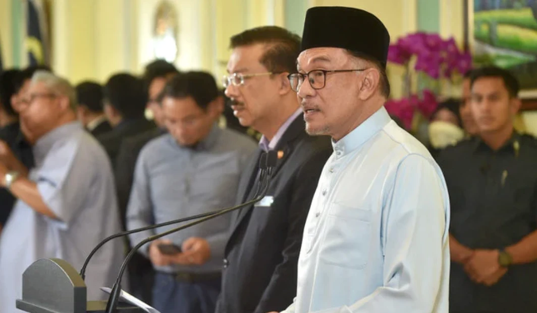 Malaysia’s Prime Minister Anwar Ibrahim speaks during a press conference to announce new cabinet members at the Prime Minister’s office in Putrajaya on December 2, 2022. (AFP)