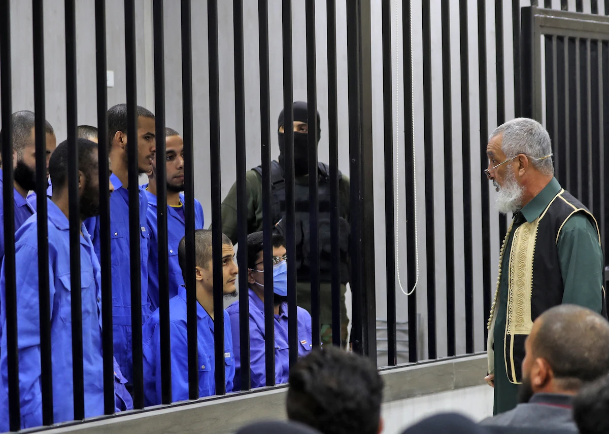 Suspected members of the Islamic State group sit in the defendant's cage during their trial in Misrata, Libya on Sept. 25. (File/AFP)