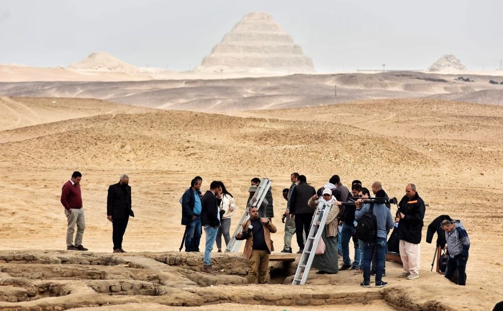 Reporters prepare to enter a recently discovered tomb near the famed Step Pyramid, in Saqqara, south of Cairo, Egypt, March 19, 2022. (AP Photo)