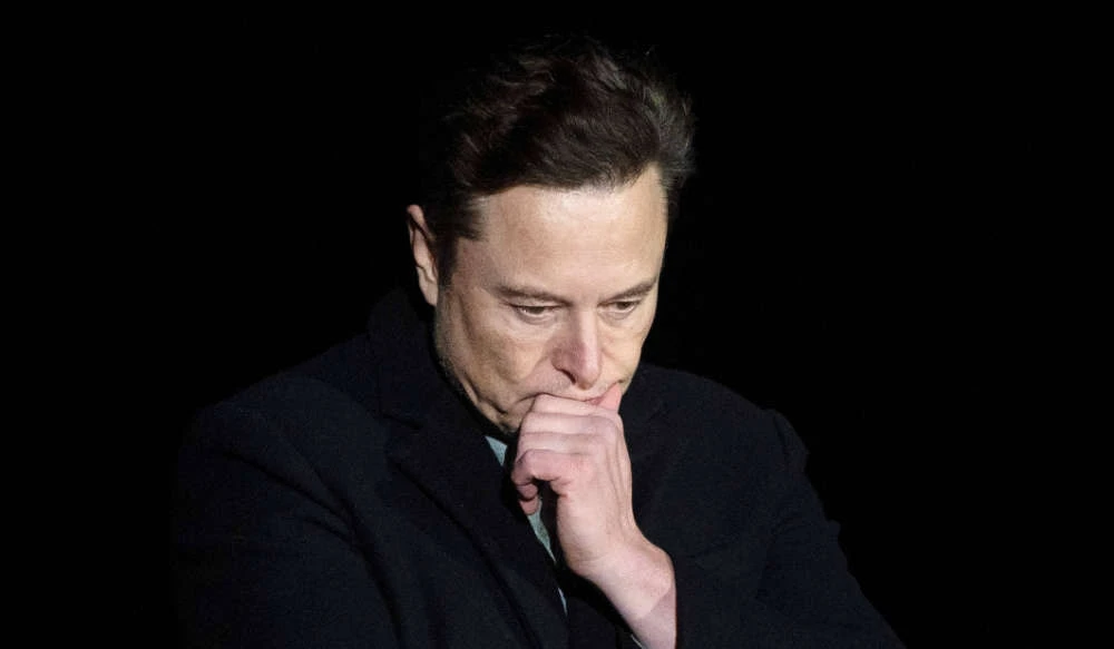 In this file photo taken on February 10, 2022 Elon Musk pauses and looks down as he speaks during a press conference at SpaceX's Starbase facility near Boca Chica Village in South Texas. (AFP)